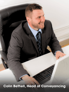 Colin Bethell, Head of Conveyancing at Pabla & Pabla Solicitors, Manchester, is seen smiling as he deals with yet another property transaction.