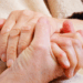 Comforting hands wrap themselves tenderly around the wrinkled old hands of a beloved elderly relative. The inference is clear, and tragic. This elderly person has choked on an incontinence pad.