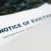 A letter is seen open on a kitchen worktop, revealing a letterhead warning of a Notice Of Eviction.