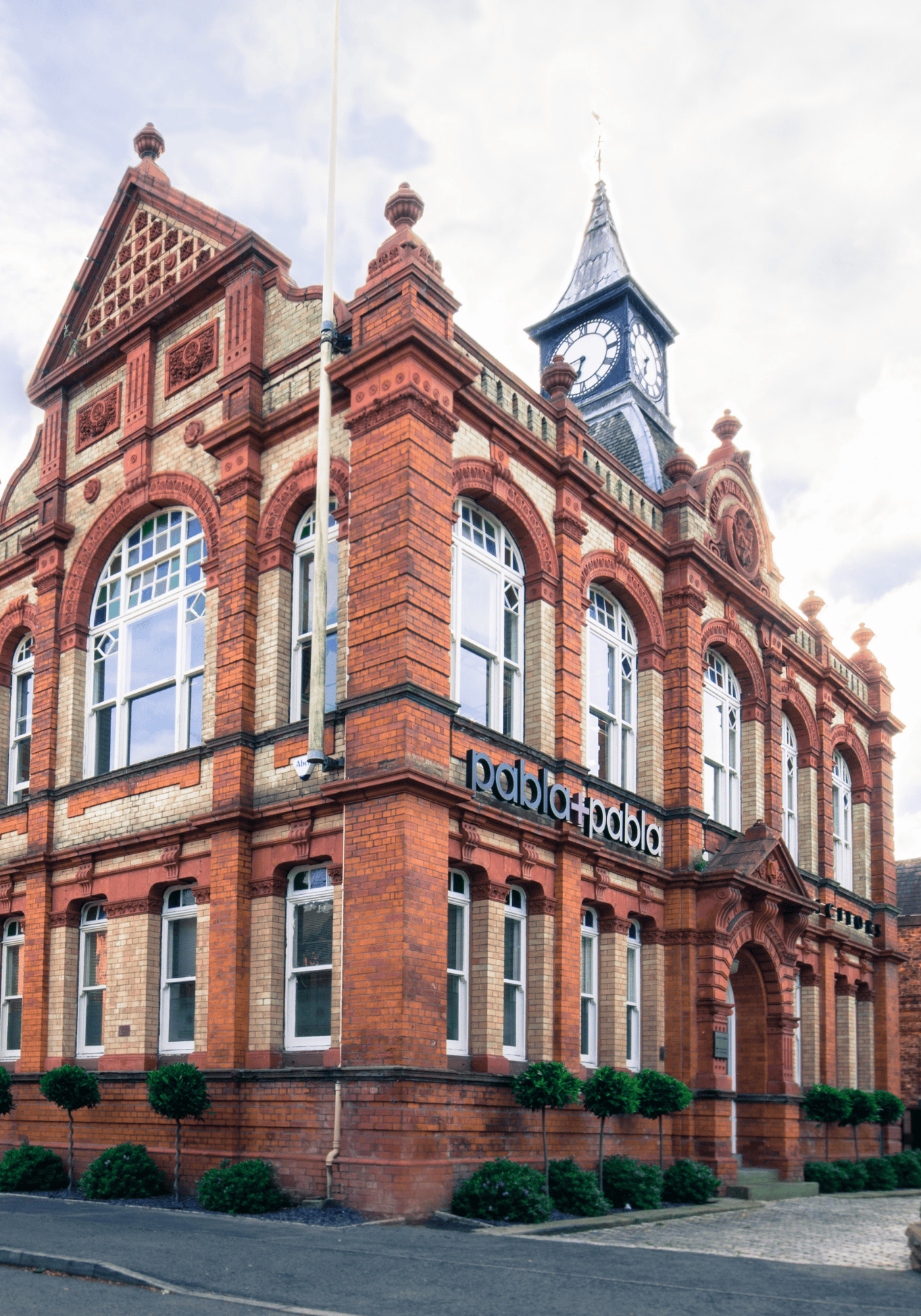 The Old Town Hall on Lapwing Lane, West Didsbury, is seen from the side. The exterior facade is in buff brick and red terracotta.