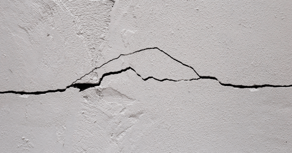 Lo, and behold a foul crack across the whitened plasterboard of a rental property. The house is clearly in disrepair, and cannot stand.